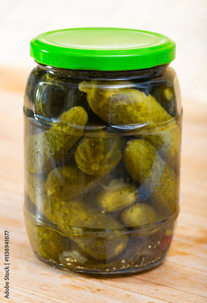 Image of glass jar with pickled cucumbers on wooden background Image of glass jar with pickled cucumbers on wooden background