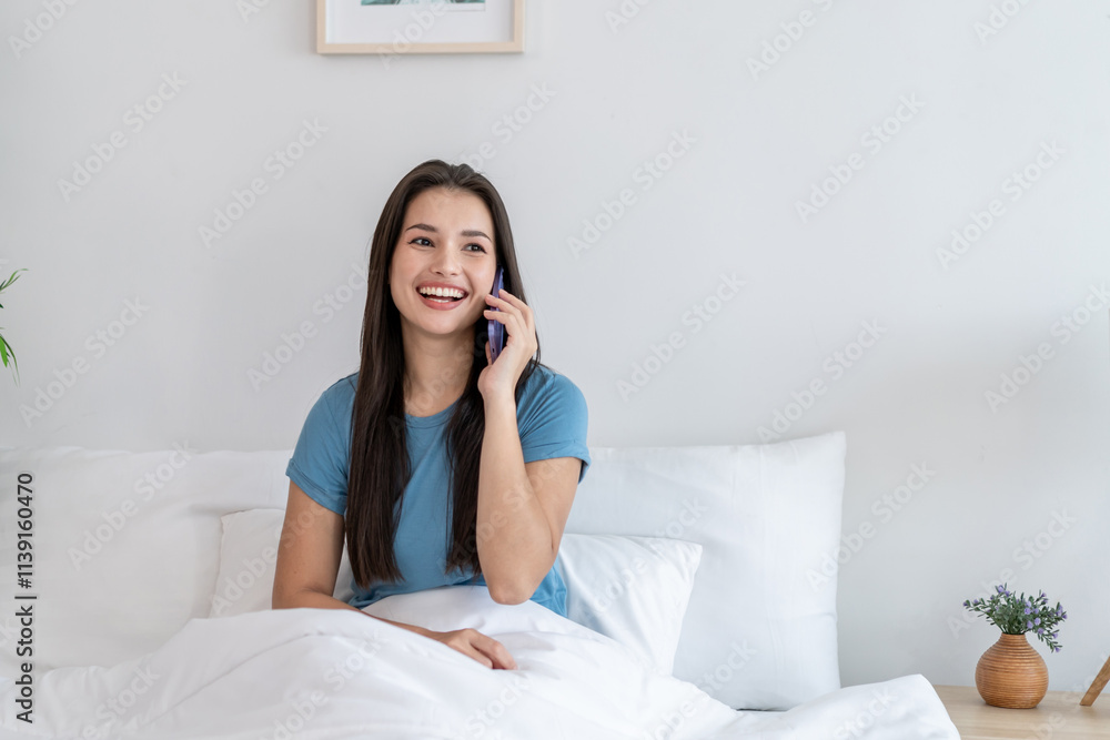 Asian attractive woman talking on mobile phone in house during morning. Asian attractive woman talking on mobile phone in house during morning.