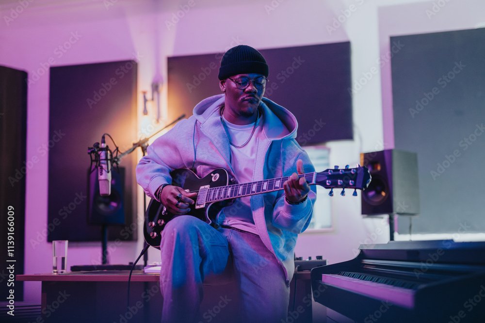 A guitarist focused on playing music in a studio. The scene is set with professional audio equipment and ambient lighting, emphasizing creativity and musical production. A guitarist focused on playing music in a studio. The scene is set with professional audio equipment and ambient lighting, emphasizing creativity and musical production.