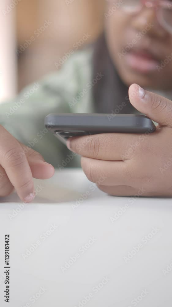 A Childs Hand Skillfully Using a Smartphone with a Focused and Engaging Gesture A Childs Hand Skillfully Using a Smartphone with a Focused and Engaging Gesture