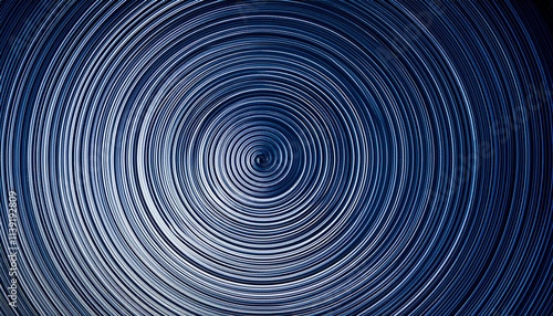 Abstract swirling concentric circles in shades of blue.