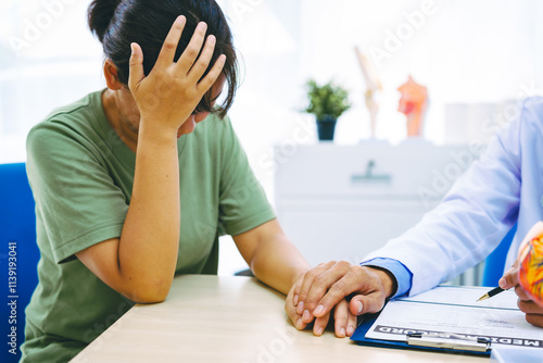 A woman with heart disease visits a doctor at the table in a hospital. The doctor explains conditions like coronary artery disease, arrhythmia,and heart valve disease,providing advice and medication photo