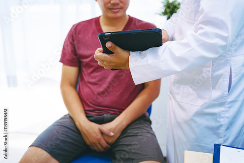 A man suffering from urinary tract infections visits a doctor at the examination table in a hospital.symptoms, discusses benign prostatic hyperplasia (BPH), and provides advice and treatment photo