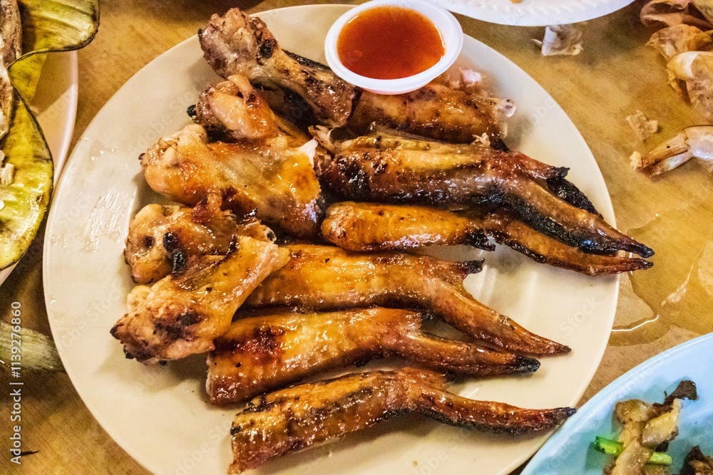 Delicious Grilled Chicken Wings with Dipping Sauce on a Plate Delicious Grilled Chicken Wings with Dipping Sauce on a Plate