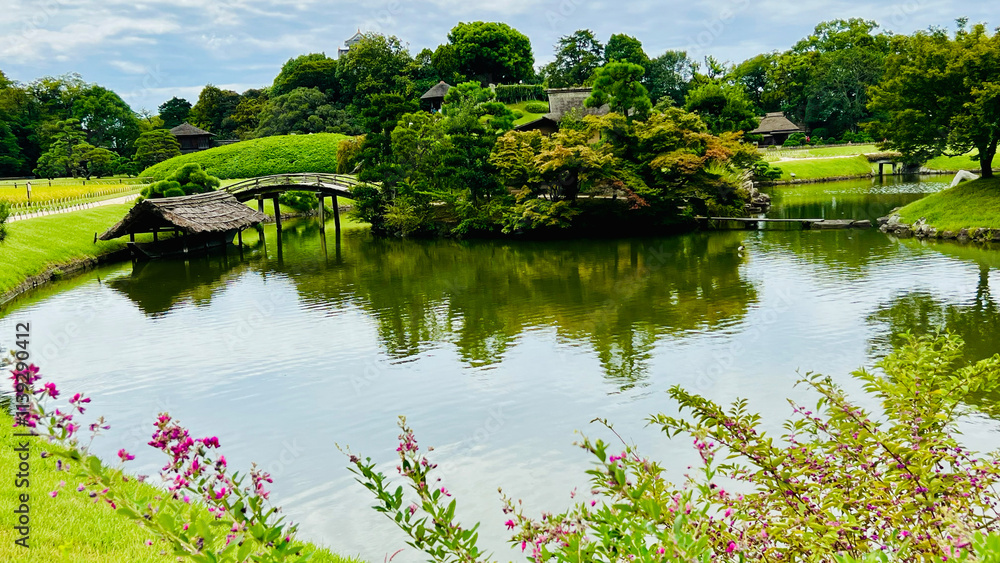 landscape of trees, bridge and pond at Okayama Korakuen Garden, Japan landscape of trees, bridge and pond at Okayama Korakuen Garden, Japan
