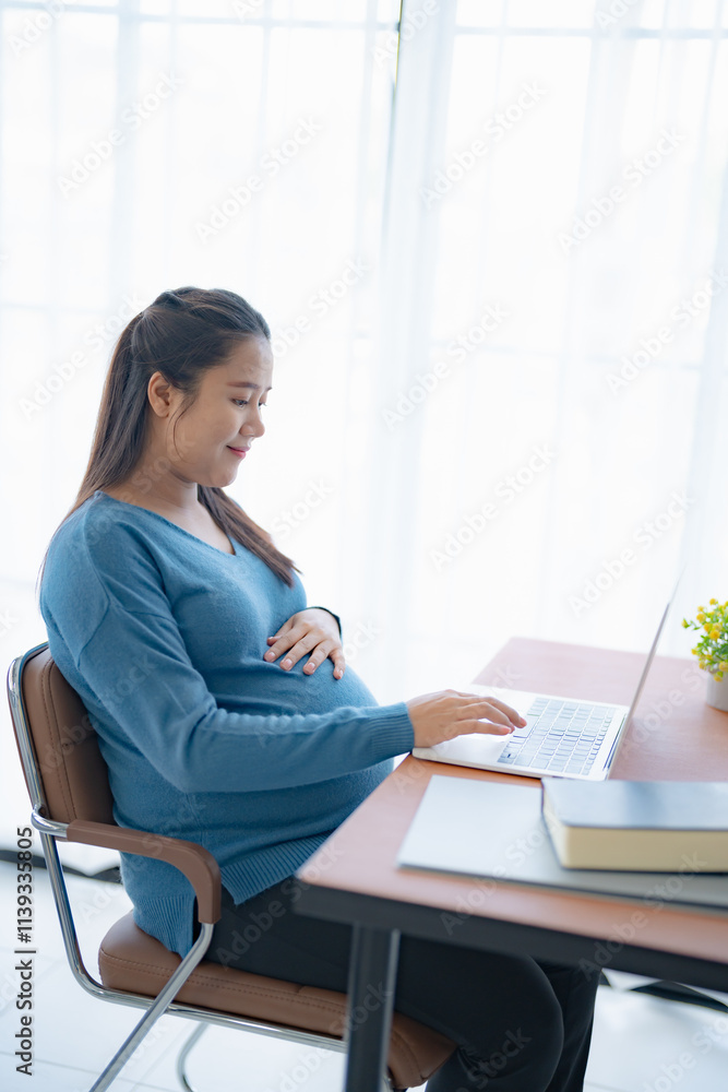 Pregnant asian woman using laptop at home pregnant businesswoman typing on laptop working on remote project in home office pregnancy concept Pregnant asian woman using laptop at home pregnant businesswoman typing on laptop working on remote project in home office pregnancy concept
