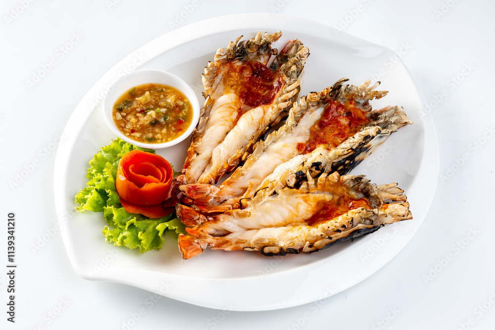 Grilled giant river prawn served on a plate with Thai seafood sauce. On a white background Grilled giant river prawn served on a plate with Thai seafood sauce. On a white background