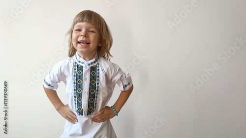A little boy dressed in Ukrainian traditional clothes, vyshyvanka. Smiling child looking at the camera. Portrait of a little kid smiling child looking at the camera. Children's smile. Close-up face