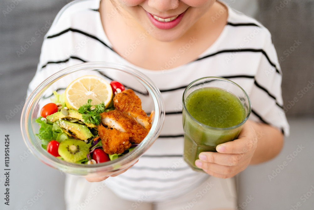 Beautiful Asian woman holding a bowl of salad and green vegetable and fruit juice. Healthy food Beautiful Asian woman holding a bowl of salad and green vegetable and fruit juice. Healthy food