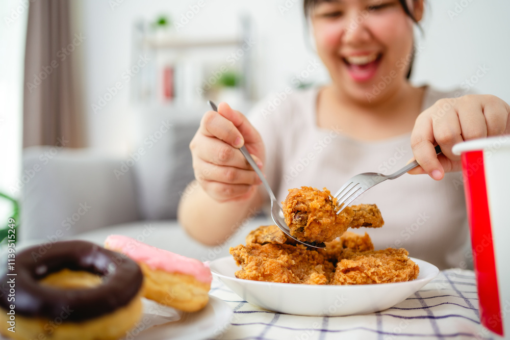 Beautiful Asian woman eating fried chicken, smiling with a happy face. Beautiful Asian woman eating fried chicken, smiling with a happy face.
