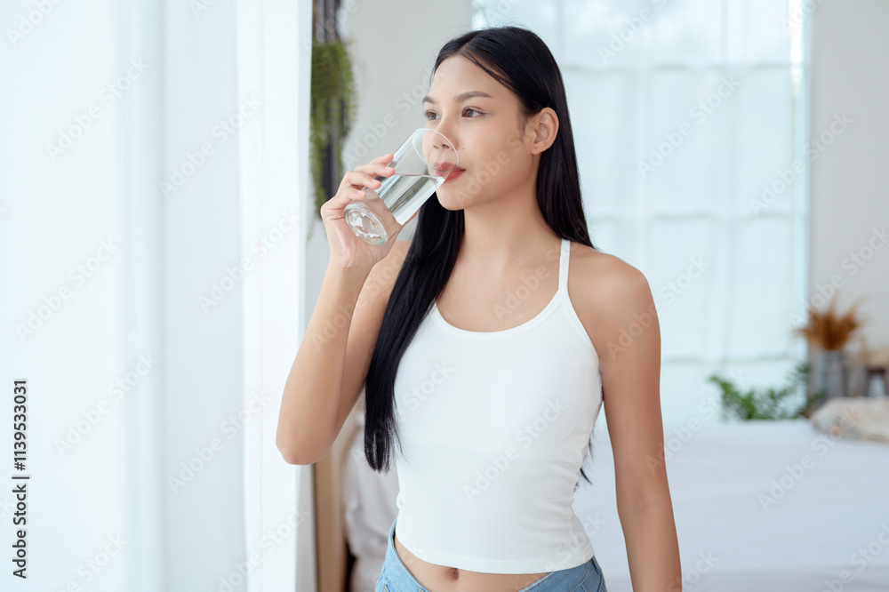 Young asian woman drinking water bedroom at home Young asian woman drinking water bedroom at home