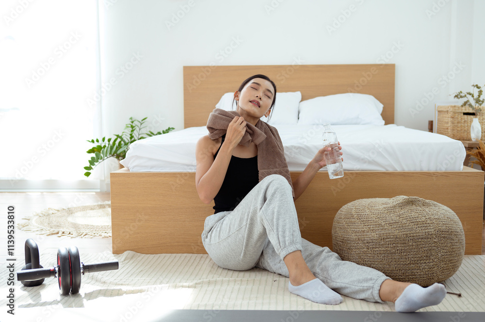 young Asian sporty woman drinking water after workout young Asian sporty woman drinking water after workout