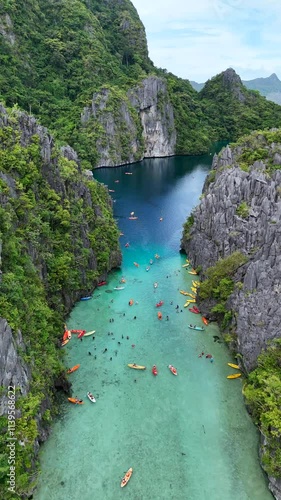 Scenic Lagoon with Kayaks Surrounded by Limestone Cliffs and Greenery