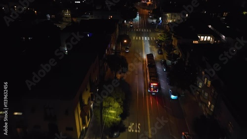 Aerial view followng a light rail on the illuminated streets of San Francisco photo