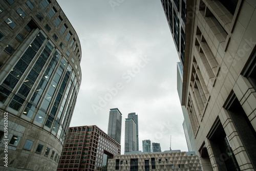 Canvas Print Modern skyscrapers reaching for the cloudy sky in canary wharf, london