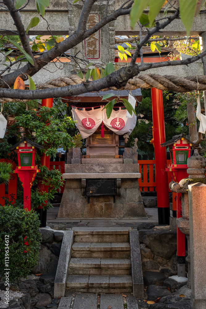 A hidden shrine is lit with afternoon light in Japan. A hidden shrine is lit with afternoon light in Japan.