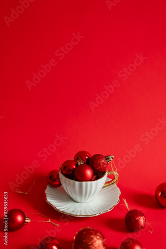 Christmas red background with ornaments in a cup photo