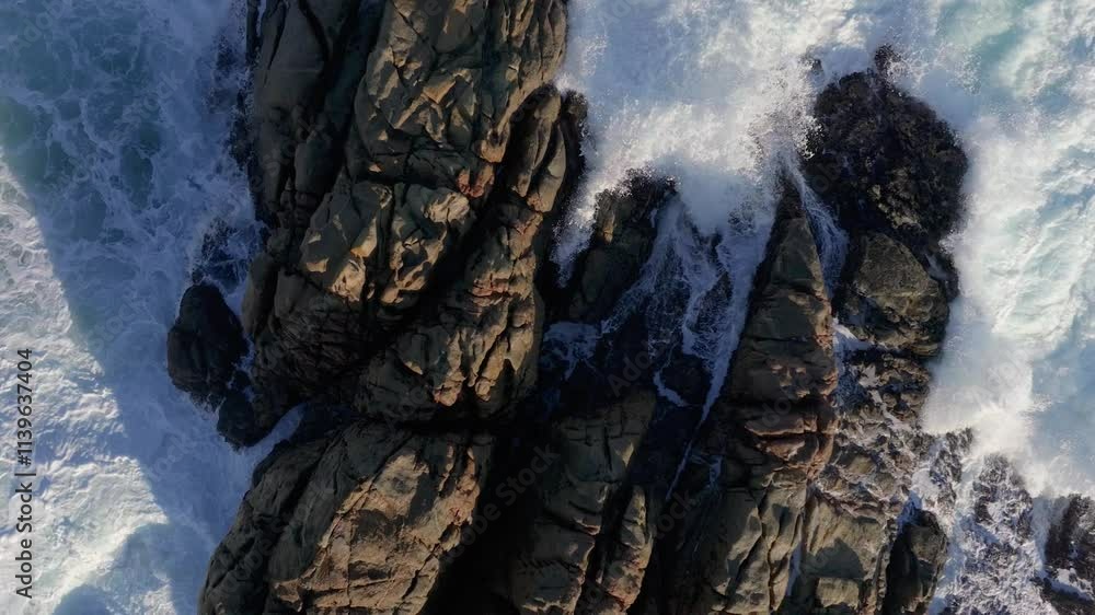 Rough Waves Breaking Onto Rocks. Aerial Slow Motion Shot Rough Waves Breaking Onto Rocks. Aerial Slow Motion Shot