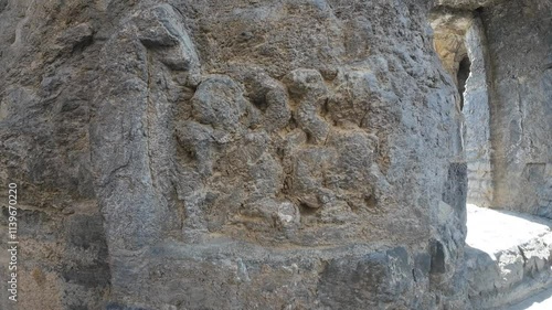 Weathered carvings on the ancient Martand Surya Temple in Jammu and Kashmir, showcasing intricate historical artistry photo