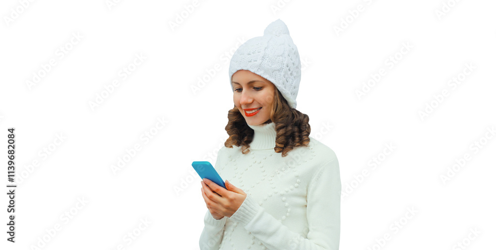 Happy smiling young woman with phone in winter hat, white sweater, girl holding smartphone isolated Happy smiling young woman with phone in winter hat, white sweater, girl holding smartphone isolated