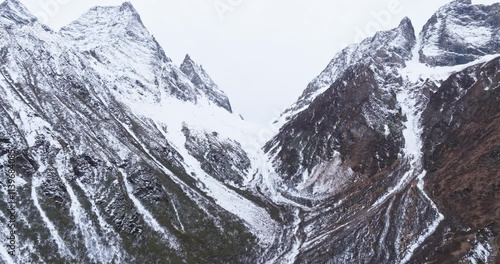 aerial view landscape of rock mountain valley in winter day with snowy summit at Sichuan China four girls mountain