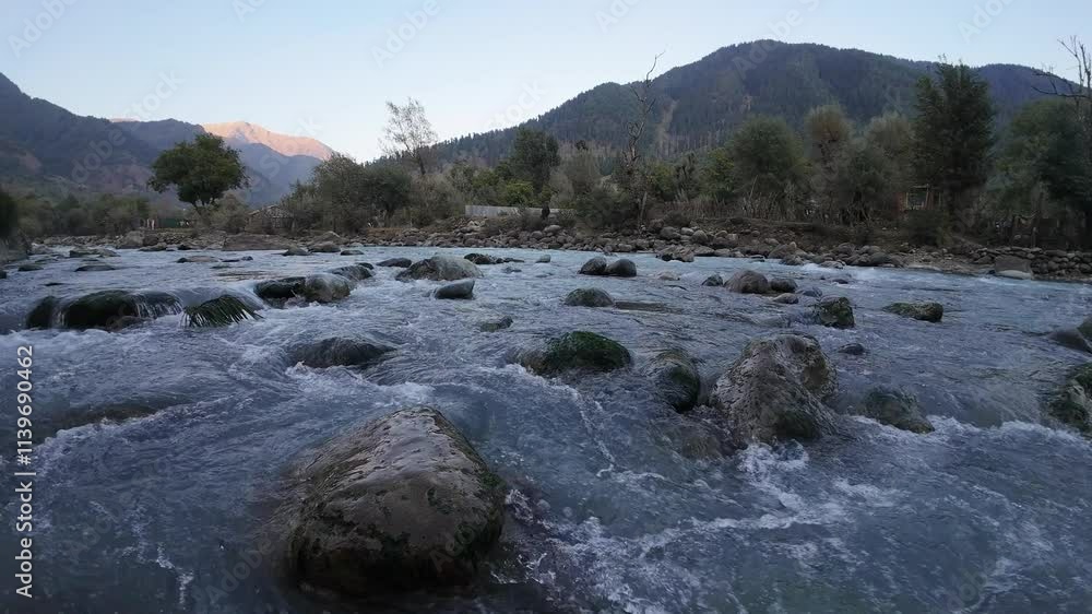 Flowing Water Stream Amidst Stones: Nature's Serene Motion Flowing Water Stream Amidst Stones: Nature's Serene Motion