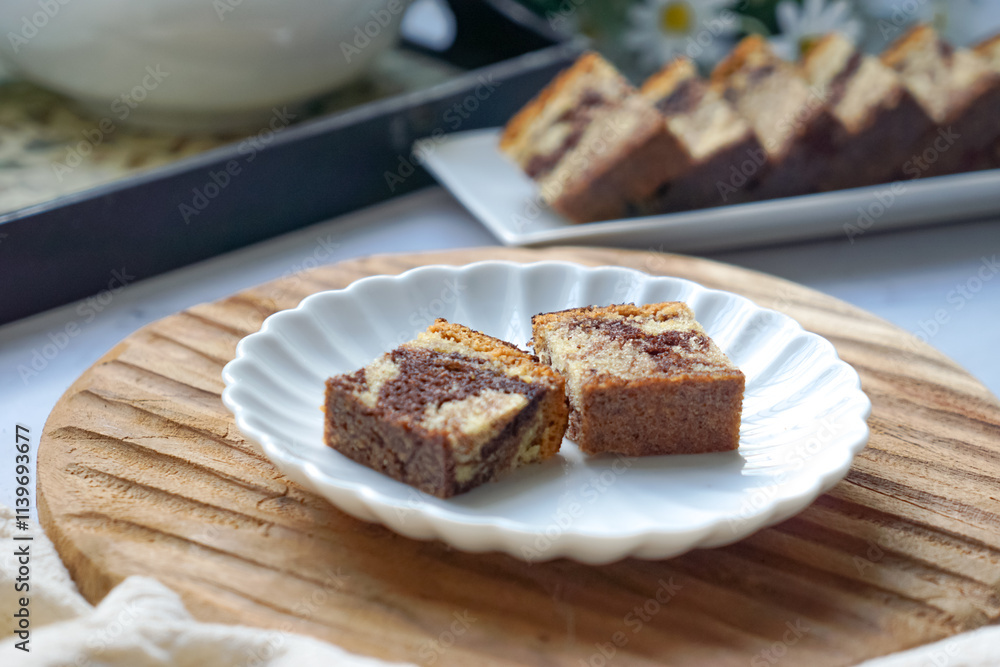 Slices of marble cake on white plates Slices of marble cake on white plates