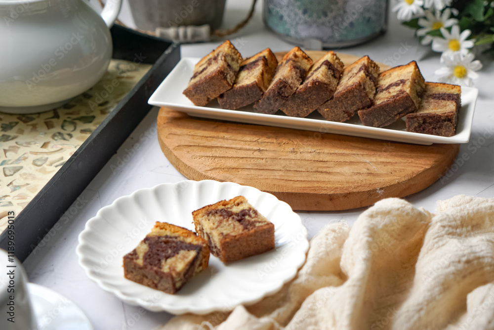 Fototapeta premium Slices of marble cake on white plates