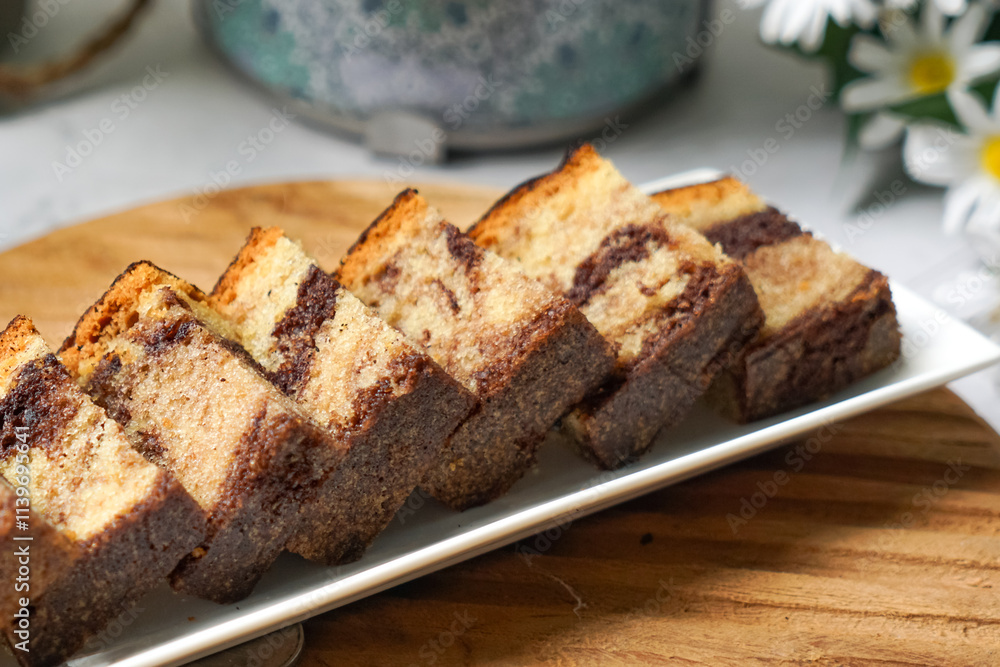 Slices of marble cake on white plates Slices of marble cake on white plates