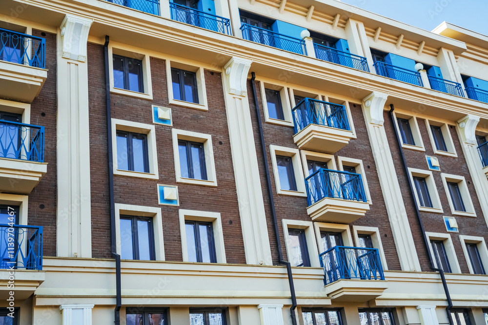 Detailed view of a stylish residential building in Irkutsk featuring vibrant balconies and large windows. Detailed view of a stylish residential building in Irkutsk featuring vibrant balconies and large windows.