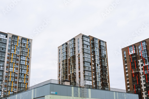 New apartment complexes rise against the overcast sky, showcasing contemporary architecture in Irkutsk. photo