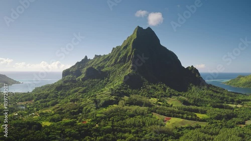 Aerial drone footage stunning beauty of Moorea, French Polynesia, with mountain rotui towering over the lush green landscape and tranquil Opunohu bay. Remote wild nature paradise, exotic summer travel photo