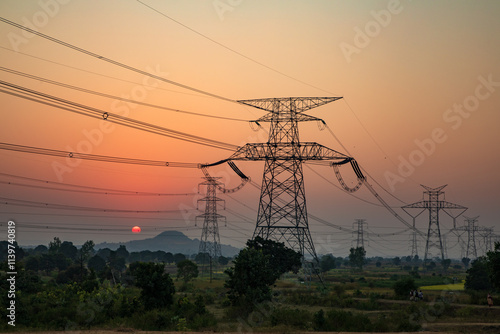 high-voltage power lines at sunset, high voltage electric transmission tower