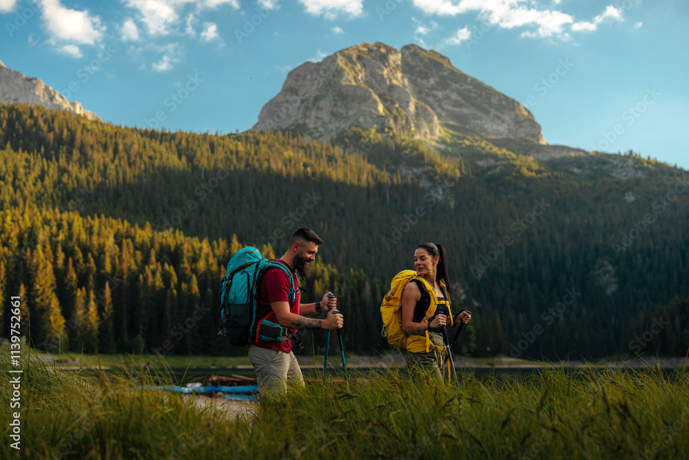 Fototapeta premium Two hikers with a scenic view behind them