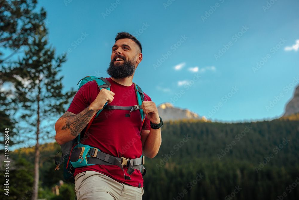 Fototapeta premium Smiling hiker in mountainous landscape