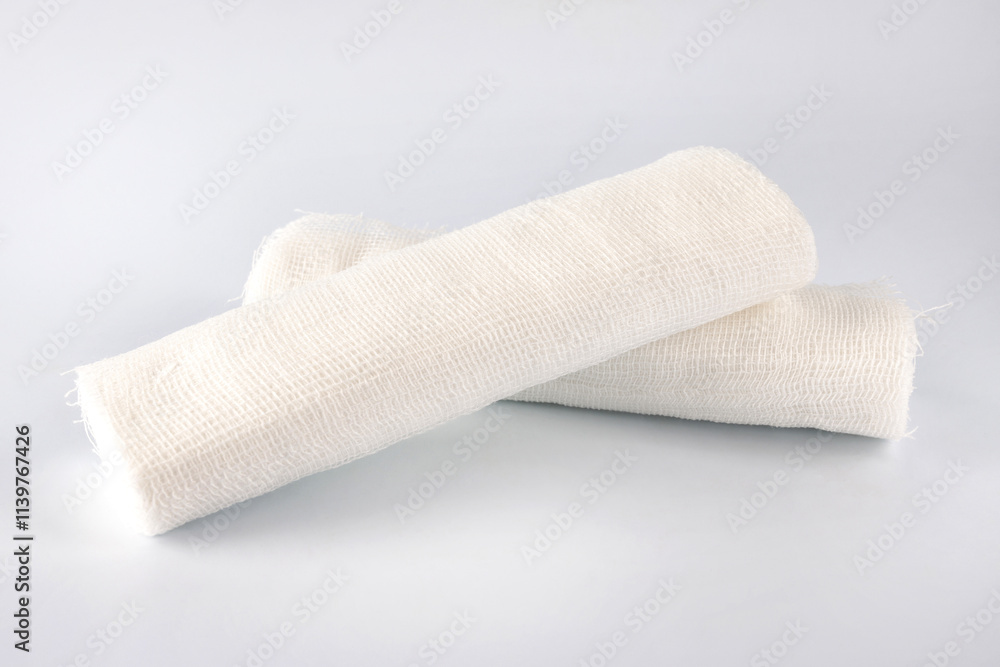 Obraz premium Gauze medical bandage. Two rolls of bandage on a white background.