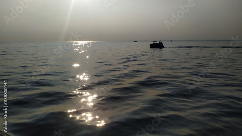 Dramatic view of a serene sunset reflecting on the tranquil Marmara waters. The photo was taken on the sea of Marmara on the way back to Istanbul from Büyükada. photo