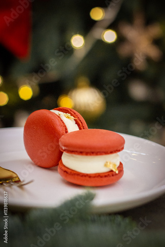 Two delicious red Macarons with Christmas Tree Lights in the Background