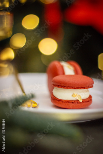Two Red Macarons with Christmas Tree Lights in the Background