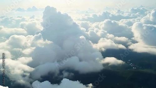 vue aérienne au dessus des nuages qui se dissipe et laisse voir un paysage . photo