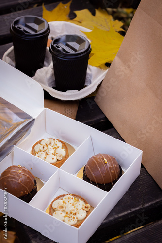 Park Scene with a Bench, Coffee Paper Cups, Dessert Box, and Paper Bag in the Background