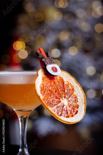 Orange Cocktail Decorated with Dried Grapefruit and a Reindeer Clothespin, Blurred Christmas Tree Lights in the Background