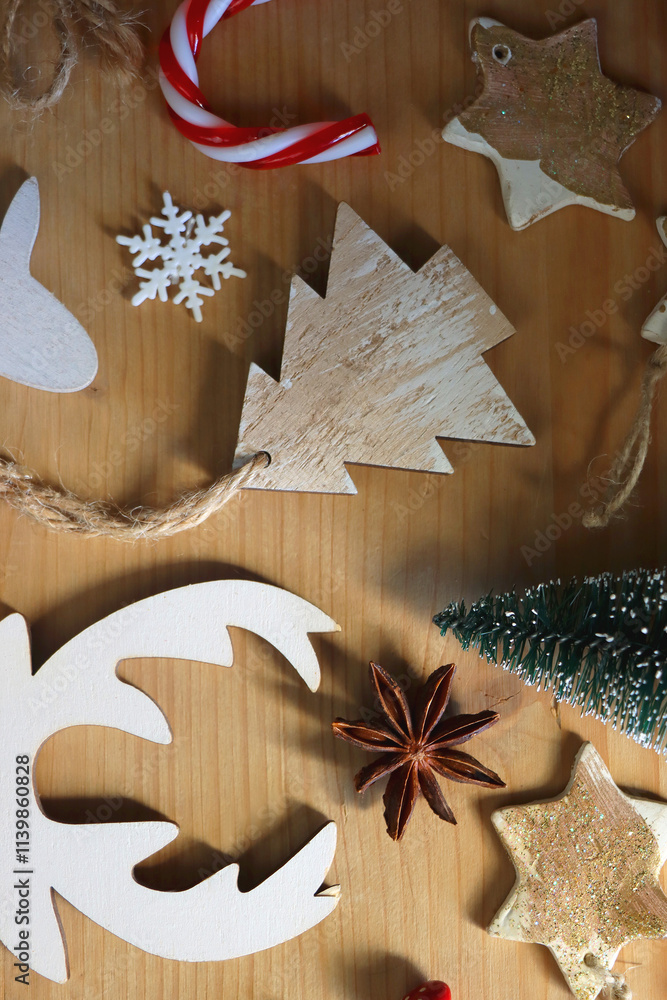Various Christmas decorations in neutral colors on wooden background. Flat lay.