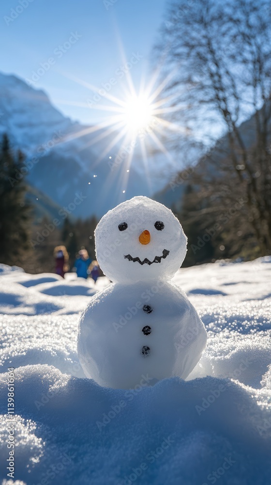 Sunlit winter landscape with partially built snowman and mountains Sunlit winter landscape with partially built snowman and mountains
