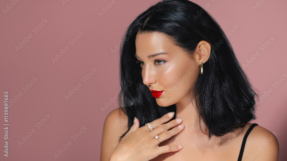 Elegant Asian woman with red lipstick, glowing skin, and jewelry posing against a pink background. Perfect for beauty, fashion, and cosmetics promotions. High-quality image ideal for advertisements Elegant Asian woman with red lipstick, glowing skin, and jewelry posing against a pink background. Perfect for beauty, fashion, and cosmetics promotions. High-quality image ideal for advertisements