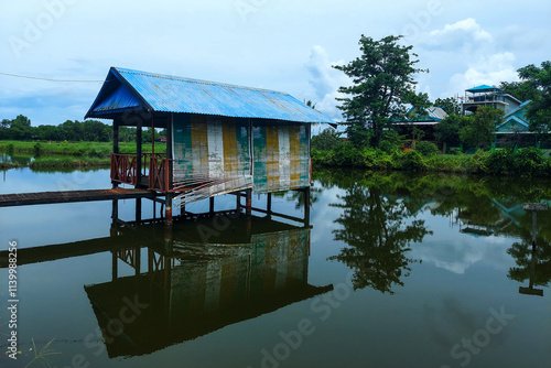 View of a wooden Gezebo above the lake in the morning