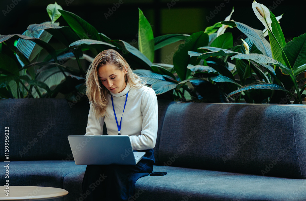 Fototapeta premium Young female professional working in a sustainable office space