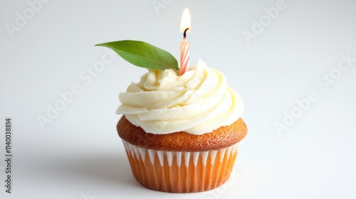 Delicious vanilla cupcake topped with creamy frosting and a single pink candle on a white background, celebrating a special occasion with elegance and style photo