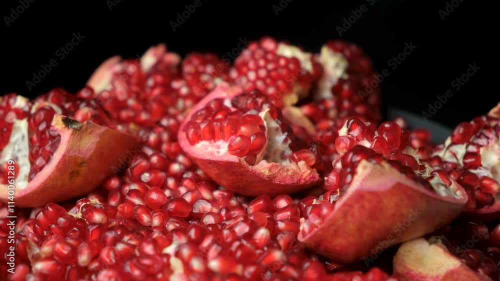 Rotation of pomegranate slices and grains on a black background. Rotation of pomegranate slices and grains on a black background.