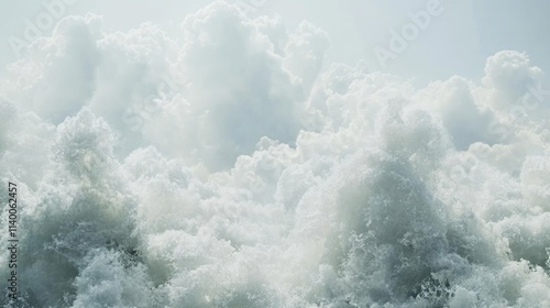 Dramatic cloudy sky illuminating powerful crashing ocean waves in a serene coastal scene